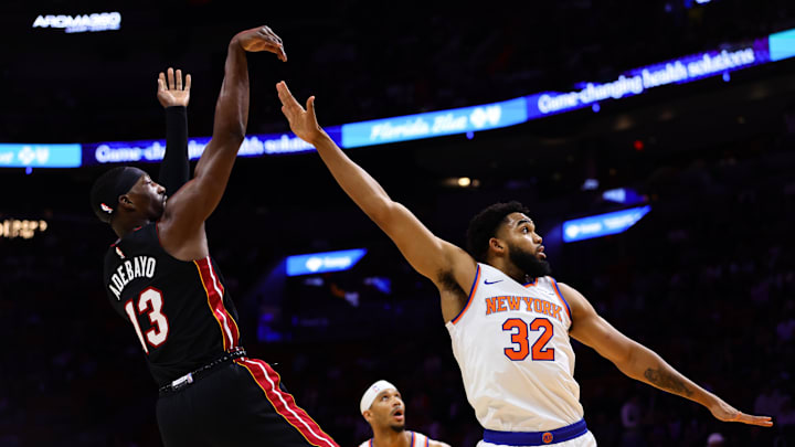 Oct 30, 2024; Miami, Florida, USA; Miami Heat center Bam Adebayo (13) shoots the basketball over New York Knicks center Karl-Anthony Towns (32) during the first quarter at Kaseya Center. Mandatory Credit: Sam Navarro-Imagn Images
