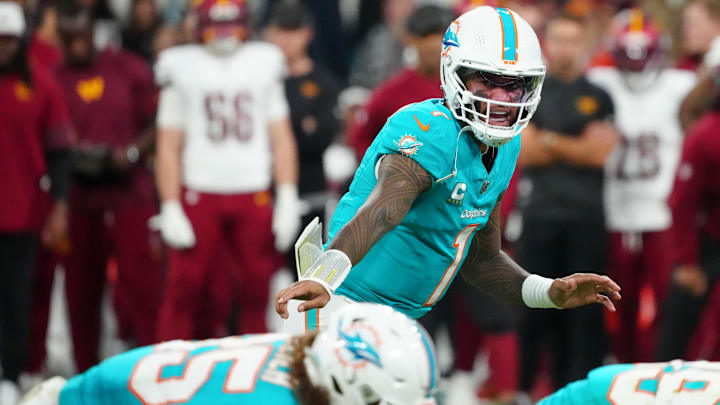 Miami Dolphins quarterback Tua Tagovailoa (1) calls a play at the line of scrimmage against the Washington Commanders in the second quarter during the 2025 NFL Madrid Game at Santiago Bernabeu Stadium. 