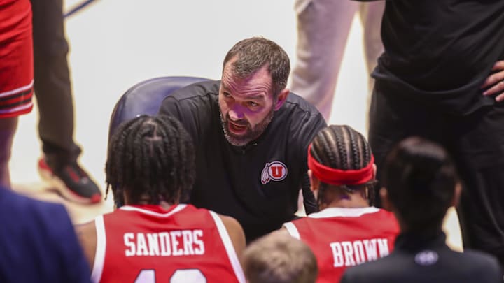 Utah Runnin' Utes head coach Alex Jensen talks to his players during a timeout during the first half against the West Virginia Mountaineers at Hope Coliseum.