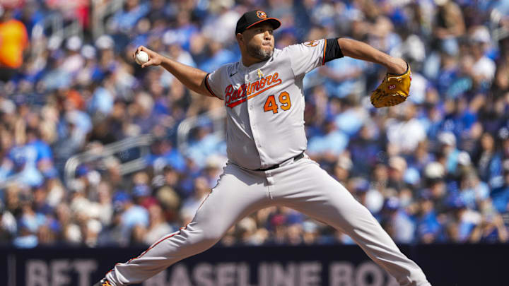 Sep 14, 2025; Toronto, Ontario, CAN; Baltimore Orioles pitcher Albert Suárez (49) delivers a pitch against the Toronto Blue Jays during the first inning at Rogers Centre. Mandatory Credit: Kevin Sousa-Imagn Images