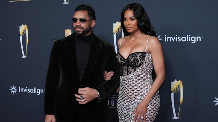 Feb 5, 2026; San Francisco, CA, USA; Russell Wilson (left) and wife Ciara pose on the NFL Honors Red Carpet before Super Bowl LX at Palace of Fine Arts. 