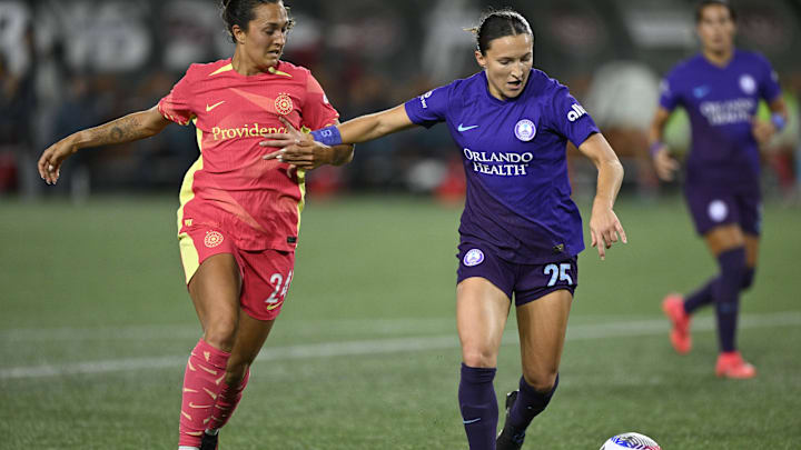 Oct 11, 2024; Portland, Oregon, USA; Orlando Pride defender Kerry Abello (25) battles Portland Thorns FC forward Izzy D'Aquila (24) for control of a ball during the second half at Providence Park. Mandatory Credit: Troy Wayrynen-Imagn Images