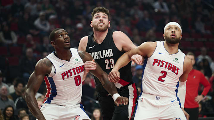 Dec 22, 2025; Portland, Oregon, USA; Detroit Pistons center Jalen Duren (0) and guard Cade Cunningham (2) vie for position on a free throw shot against Portland Trail Blazers center Donovan Clingan (23) during the first half at Moda Center. Mandatory Credit: Troy Wayrynen-Imagn Images