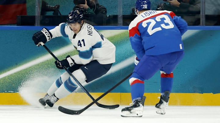 Feb 11, 2026; Milan, Italy; Miro Heiskanen of Finland in action with Adam Liska of Slovakia in men's ice hockey group B play during the Milano Cortina 2026 Olympic Winter Games at Milano Santagiulia Ice Hockey Arena. Mandatory Credit: Geoff Burke-Imagn Images