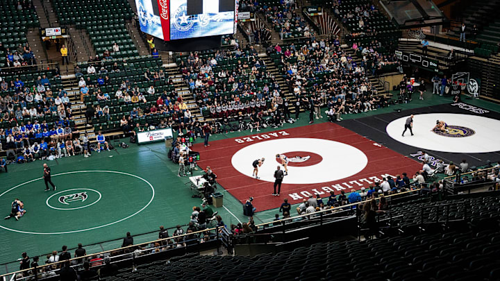 Wrestling matches are seen on three different mats during the 'Moby Mat Madness' district wrestling event on Dec. 17, 2025 at CSU's Moby Arena in Fort Collins, Colo.