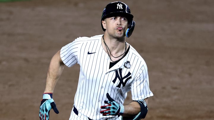 Oct 30, 2024; New York, New York, USA; New York Yankees designated hitter Giancarlo Stanton (27) rounds the bases after hitting a home run during the third inning against the Los Angeles Dodgers in game five of the 2024 MLB World Series at Yankee Stadium.