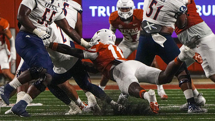 Texas Longhorns edge Colin Simmons (11) sacks UTSA quarterback Owen McCown (2) during the game at Darrell K Royal-Texas Memorial Stadium in Austin Saturday, Sept. 14, 2024.