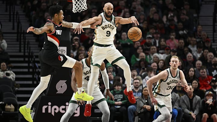 Mar 11, 2024; Portland, Oregon, USA: Boston Celtics guard Derrick White (9) steals a pass during the first half against Portland Trail Blazers guard Anfernee Simons (1) at Moda Center. Mandatory Credit: Troy Wayrynen-Imagn Images