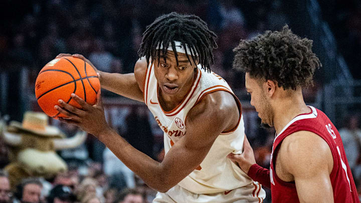 Texas Longhorns guard Tre Johnson (20) looks for an opening as Alabama Crimson Tide guard Mark Sears (1) defends in the first half as the Texas Longhorns take on the Crimson Tide at the Moody Center, Feb. 11, 2025.