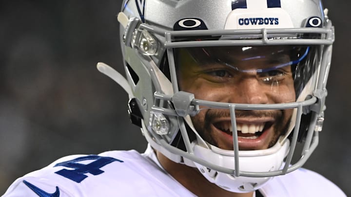 Dallas Cowboys quarterback Dak Prescott smiles on the field after a touchdown pass. 