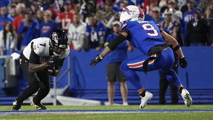 Sep 7, 2025; Orchard Park, New York, USA;  Baltimore Ravens wide receiver Rashod Bateman (7) holds the ball against Buffalo Bills safety Taylor Rapp (9) during the second quarter at Highmark Stadium. Mandatory Credit: Gregory Fisher-Imagn Images