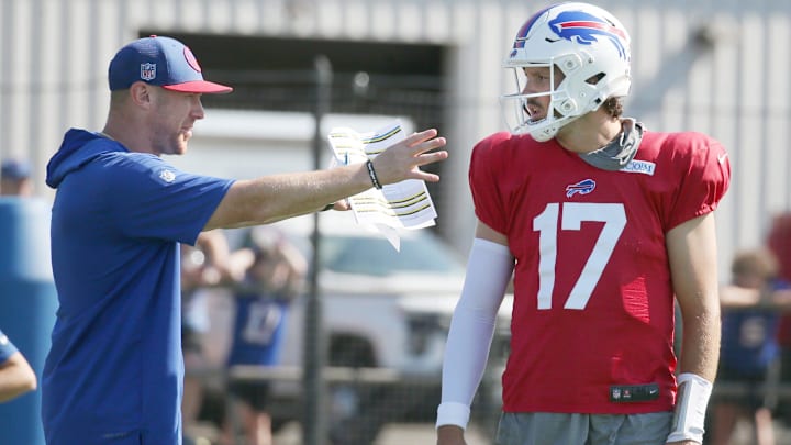 Buffalo Bills quarterback Josh Allen talks with offensive coordinator Joe Brady between drills.