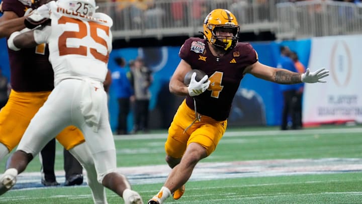 Arizona State running back Cam Skattebo (4) runs against Texas defensive back Jelani McDonald (25) during the third quarter of the Chick-fil-A Peach Bowl in Atlanta on Wednesday, Jan. 1, 2025. Arizona State running back Cam Skattebo (4) runs against Texas defensive back Jelani McDonald (25) during the third quarter of the Chick-fil-A Peach Bowl in Atlanta on Wednesday, Jan. 1, 2025.