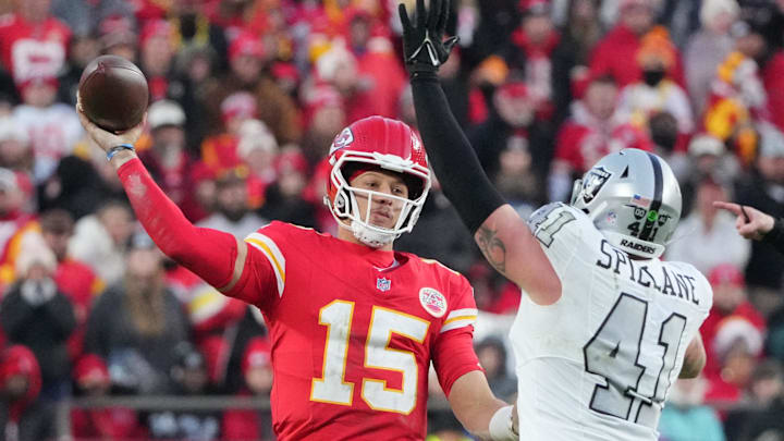 Nov 29, 2024; Kansas City, Missouri, USA; Kansas City Chiefs quarterback Patrick Mahomes (15) throws a pass as Las Vegas Raiders linebacker Robert Spillane (41) defends  during the second half at GEHA Field at Arrowhead Stadium. Mandatory Credit: Denny Medley-Imagn Images