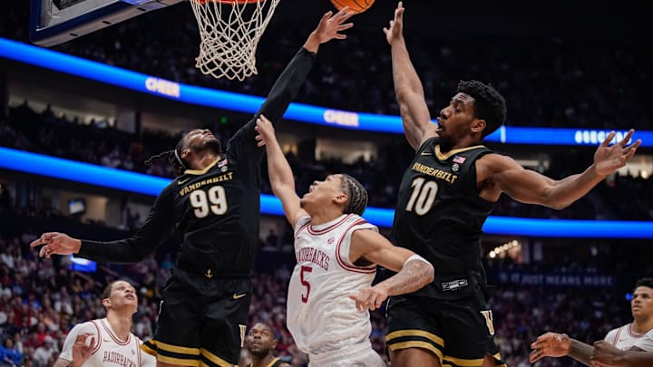 Vanderbilt forward Devin McGlockton (99), forward Ak Okereke (10) and Arkansas guard Darius Acuff Jr. (5) scramble for a rebound during the second half of the SEC tournament championship game at Bridgestone Arena in Nashville, Tenn., Sunday, March 15, 2026. Vanderbilt forward Devin McGlockton (99), forward Ak Okereke (10) and Arkansas guard Darius Acuff Jr. (5) scramble for a rebound during the second half of the SEC tournament championship game at Bridgestone Arena in Nashville, Tenn., Sunday, March 15, 2026.