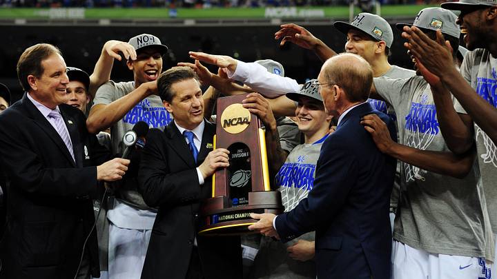 Apr 2, 2012; New Orleans, LA, USA; Kentucky Wildcats head coach John Calipari (middle) is presented with the NCAA national championship trophy after the finals of the 2012 NCAA men's basketball Final Four against the Kansas Jayhawks at the Mercedes-Benz Superdome. Kentucky won 67-59. Mandatory Credit: Bob Donnan-USA TODAY Sports Apr 2, 2012; New Orleans, LA, USA; Kentucky Wildcats head coach John Calipari (middle) is presented with the NCAA national championship trophy after the finals of the 2012 NCAA men's basketball Final Four against the Kansas Jayhawks at the Mercedes-Benz Superdome. Kentucky won 67-59. Mandatory Credit: Bob Donnan-USA TODAY Sports