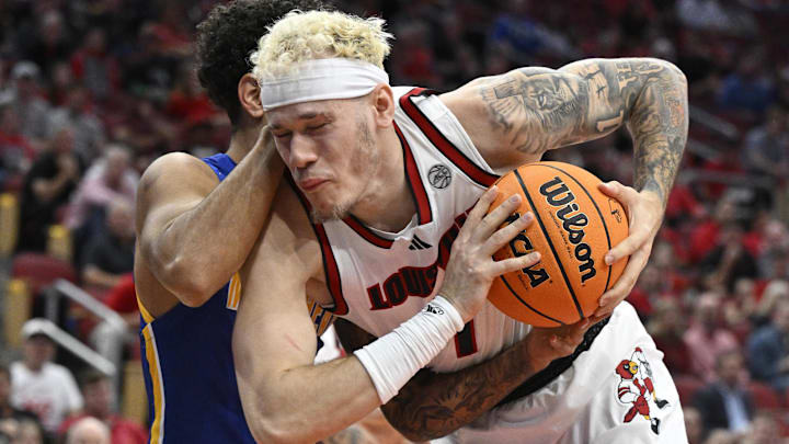 Nov 4, 2024; Louisville, Kentucky, USA; Louisville Cardinals forward Kasean Pryor (7) battles Morehead State Eagles guard Trent Scott (11) for the ball during the first half at KFC Yum! Center. Nov 4, 2024; Louisville, Kentucky, USA; Louisville Cardinals forward Kasean Pryor (7) battles Morehead State Eagles guard Trent Scott (11) for the ball during the first half at KFC Yum! Center.