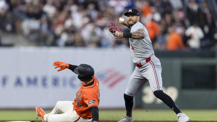 Jul 12, 2024; San Francisco, California, USA; Minnesota Twins shortstop Carlos Correa (4) throws to first base after tagging San Francisco Giants third baseman Matt Chapman (26) for a double play during the fourth inning at Oracle Park.