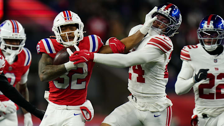 Dec 1, 2025; Foxborough, Massachusetts, USA; New England Patriots running back TreVeyon Henderson (32) runs the ball against New York Giants safety Dane Belton (24) during the fourth quarter at Gillette Stadium.