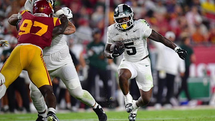 Sep 20, 2025; Los Angeles, California, USA; Michigan State Spartans running back Makhi Frazier (5) runs the ball against the Southern California Trojans during the second half at the Los Angeles Memorial Coliseum. Mandatory Credit: Gary A. Vasquez-Imagn Images
