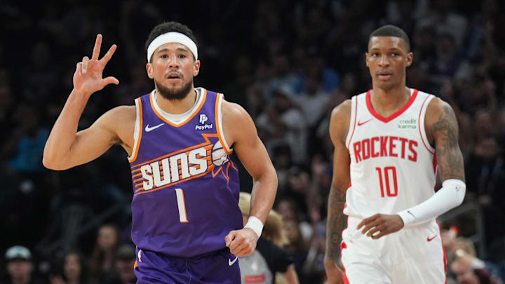 Mar 2, 2024; Phoenix, Arizona, USA; Phoenix Suns guard Devin Booker (1) reacts after making a shot against Houston Rockets forward Jabari Smith Jr. (10) during the first half at Footprint Center. Mandatory Credit: Joe Camporeale-Imagn Images