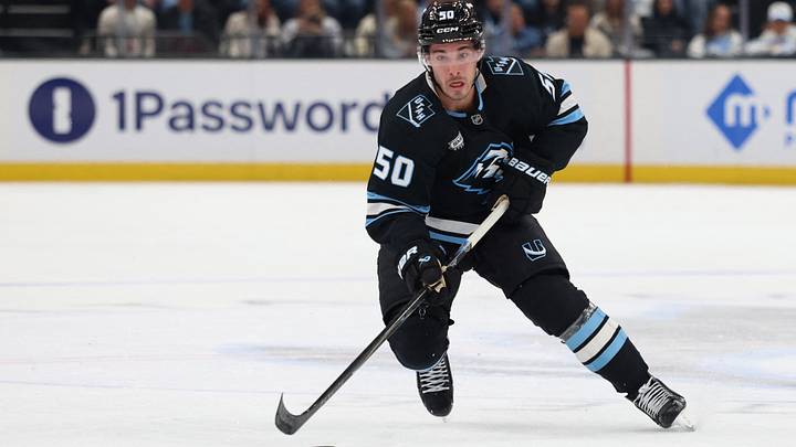 Mar 26, 2026; Salt Lake City, Utah, USA; Utah Mammoth defenseman Sean Durzi (50) skates with the puck against the Washington Capitals during the first period at Delta Center.