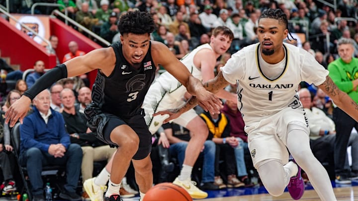 Michigan State Spartans guard Jaden Akins (3) and Oakland Golden Grizzlies guard Jaylen Jones (1) fight for the loose ball, during the 2nd period at Little Caesars Arena in Detroit on Tuesday, Dec. 17, 2024.