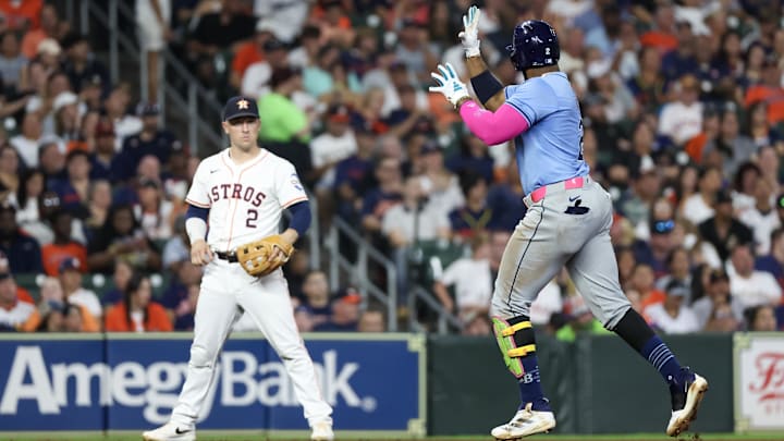 Aug 3, 2024; Houston, Texas, USA;Tampa Bay Rays first baseman Yandy Diaz (2) reacts after hitting a home run as Houston Astros third baseman Alex Bregman (2) looks on in the seven inning at Minute Maid Park.