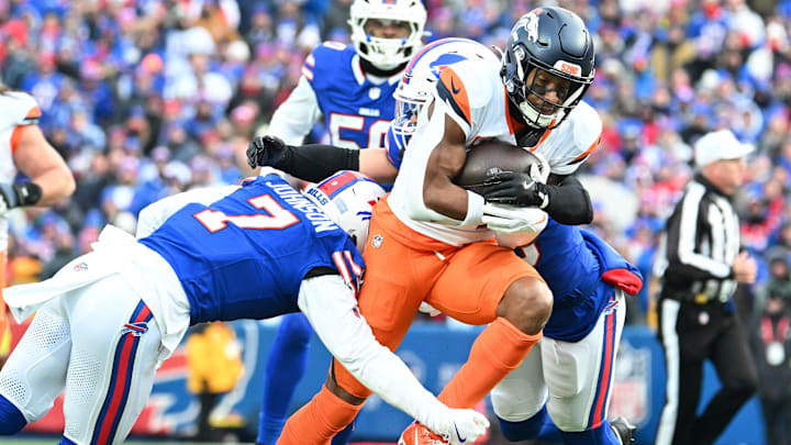 Jan 12, 2025; Orchard Park, New York, USA; Denver Broncos wide receiver Courtland Sutton (14) is tackled by Buffalo Bills cornerback Taron Johnson (7) in the fourth quarter of an AFC wild card game at Highmark Stadium. Mandatory Credit: Mark Konezny-Imagn Images Jan 12, 2025; Orchard Park, New York, USA; Denver Broncos wide receiver Courtland Sutton (14) is tackled by Buffalo Bills cornerback Taron Johnson (7) in the fourth quarter of an AFC wild card game at Highmark Stadium. Mandatory Credit: Mark Konezny-Imagn Images