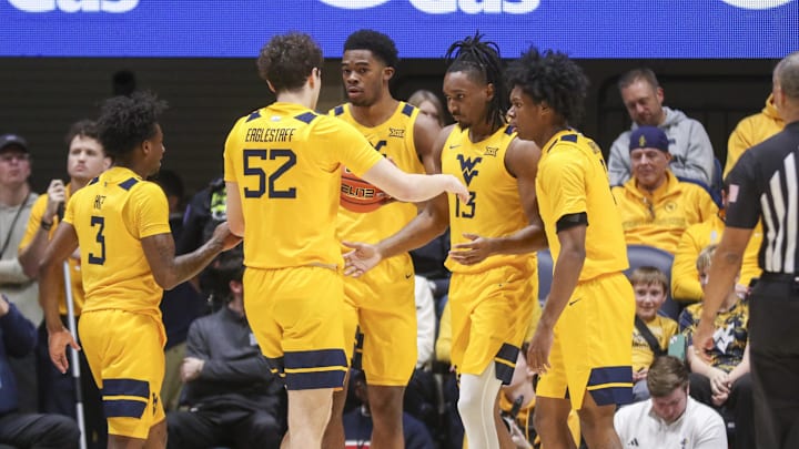 Jan 10, 2026; Morgantown, West Virginia, USA; West Virginia Mountaineers guard Chance Moore (13) celebrates with teammates after a play during the first half against the Kansas Jayhawks at Hope Coliseum. Mandatory Credit: Ben Queen-Imagn Images