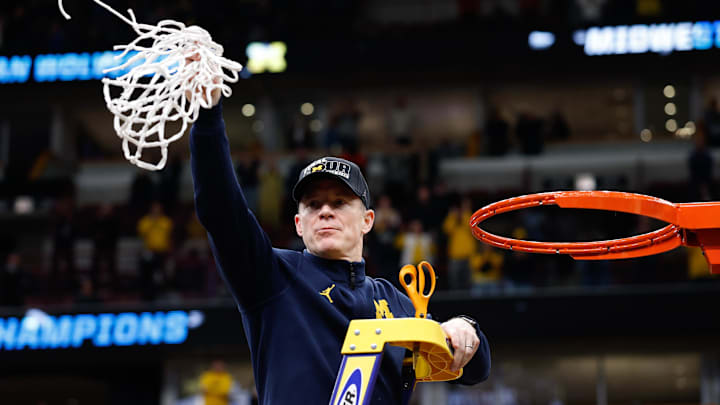 Mar 29, 2026; Chicago, IL, USA; Michigan Wolverines head coach Dusty May cuts the net after defeating the Tennessee Volunteers in an Elite Eight game of the Midwest Regional of the men's 2026 NCAA Tournament at United Center. Mandatory Credit: Kamil Krzaczynski-Imagn Images