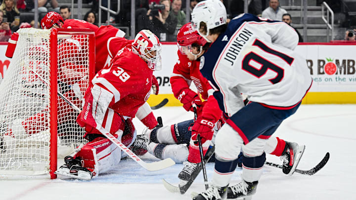 Feb 27, 2025; Detroit, Michigan, USA; Detroit Red Wings goaltender Cam Talbot (39) makes a save against Columbus Blue Jackets center Kent Johnson (91) during the first period at Little Caesars Arena. Mandatory Credit: Tim Fuller-Imagn Images