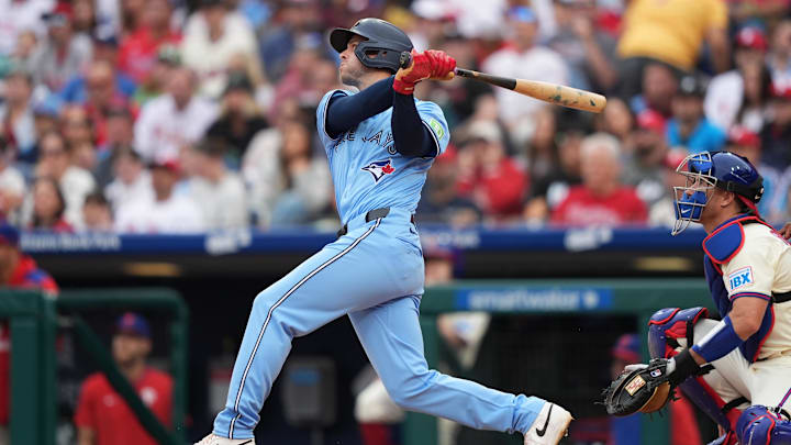 Jun 14, 2025; Philadelphia, Pennsylvania, USA; Toronto Blue Jays infielder Ernie Clement (22) hits a double against the Philadelphia Phillies in the second inning at Citizens Bank Park. Mandatory Credit: Kyle Ross-Imagn Images