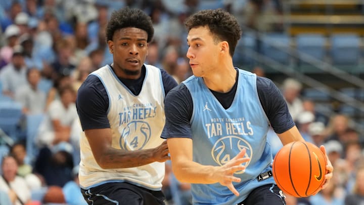 Oct 4, 2025; Charlotte, NC, USA; North Carolina Tar Heels guard Luka Bogavac (44) with the ball as guard Jaydon Young (4) defends in the second half at Dean E. Smith Center. Mandatory Credit: Bob Donnan-Imagn Images