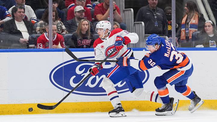 Apr 12, 2026; Elmont, New York, USA; Montréal Canadiens defenseman David Reinbacher (64) passes the puck as New York Islanders center Kyle MacLean (32) chases in the second period at UBS Arena. Mandatory Credit: Alexander Wohl-Imagn Images Apr 12, 2026; Elmont, New York, USA; Montréal Canadiens defenseman David Reinbacher (64) passes the puck as New York Islanders center Kyle MacLean (32) chases in the second period at UBS Arena. Mandatory Credit: Alexander Wohl-Imagn Images