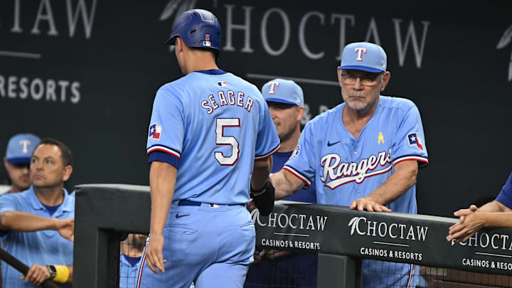 Sep 1, 2024; Arlington, Texas, USA; Texas Rangers manager Bruce Bochy (15) greets shortstop Corey Seager (5) after Seager scores a run against the Oakland Athletics during the first inning at Globe Life Field.