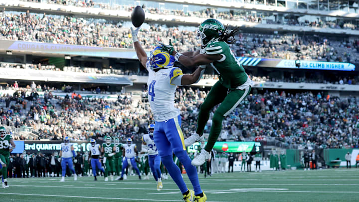 Dec 22, 2024; East Rutherford, New Jersey, USA; Los Angeles Rams cornerback Ahkello Witherspoon (4) breaks up a pass intended for New York Jets wide receiver Davante Adams (17) during the third quarter at MetLife Stadium. Mandatory Credit: Brad Penner-Imagn Images