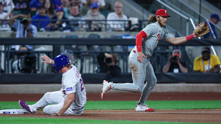 Aug 27, 2025; New York City, New York, USA; New York Mets first baseman Pete Alonso (20) slides safely in to third base as Philadelphia Phillies third baseman Alec Bohm (28)  catches the throw after a hit by left fielder Brandon Nimmo (not pictured) during the fifth inning  at Citi Field. Mandatory Credit: Vincent Carchietta-Imagn Images