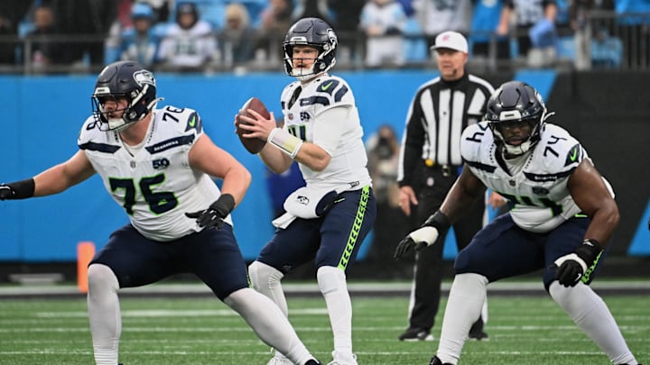 Dec 28, 2025; Charlotte, North Carolina, USA; Seattle Seahawks quarterback Sam Darnold (14) looks to throw a pass as guards Grey Zabel (76) and Josh Jones (74) block against the Carolina Panthers during the second quarter at Bank of America Stadium. Mandatory Credit: Bob Donnan-Imagn Images