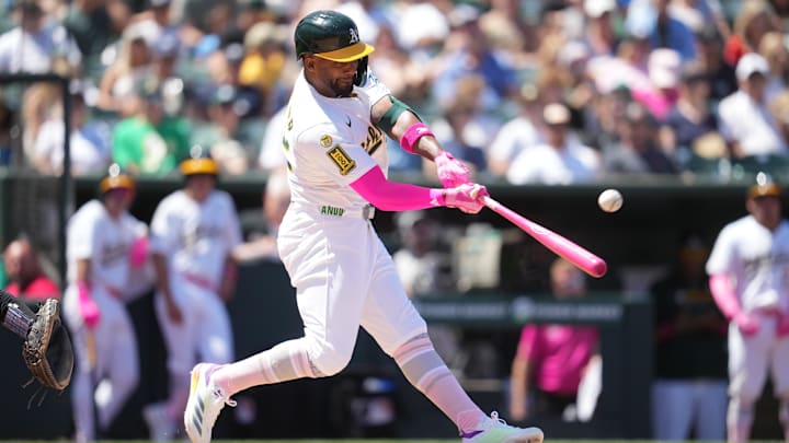 May 11, 2025; West Sacramento, California, USA; Athletics right fielder Miguel Andujar (22) hits an RBI single against the New York Yankees in the fourth inning at Sutter Health Park. Mandatory Credit: Cary Edmondson-Imagn Images