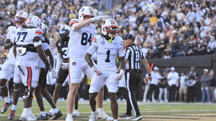 Nov 8, 2025; Nashville, Tennessee, USA; Auburn Tigers wide receiver Eric Singleton Jr. (1) celebrates with his teammates after scoring a touchdown against the Vanderbilt Commodores during the first half at FirstBank Stadium. Mandatory Credit: Steve Roberts-Imagn Images Nov 8, 2025; Nashville, Tennessee, USA; Auburn Tigers wide receiver Eric Singleton Jr. (1) celebrates with his teammates after scoring a touchdown against the Vanderbilt Commodores during the first half at FirstBank Stadium. Mandatory Credit: Steve Roberts-Imagn Images