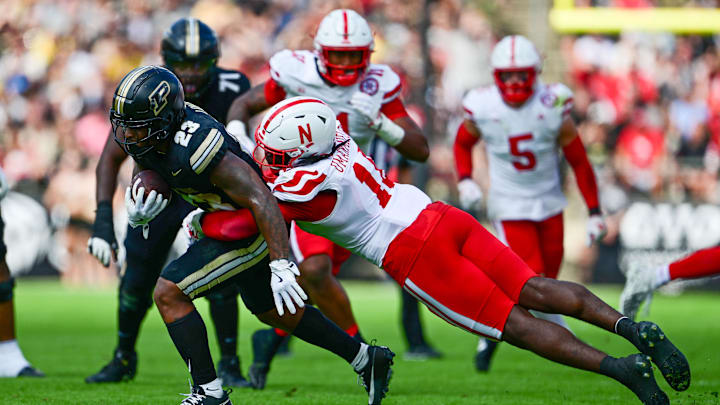 Sep 28, 2024; West Lafayette, Indiana, USA; Purdue Boilermakers running back Reggie Love III (23) is tackled by Nebraska Cornhuskers linebacker Princewill Umanmielen (18) during the second half at Ross-Ade Stadium. Mandatory Credit: Marc Lebryk-Imagn Images