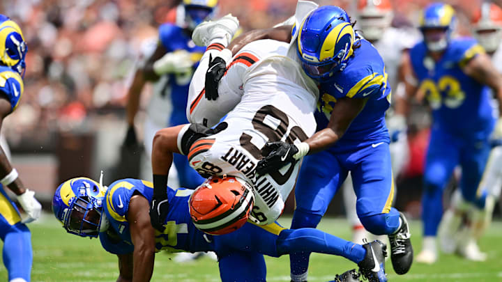 Los Angeles Rams linebacker Elias Neal (58) and safety Tanner Ingle (34) tackle Cleveland Browns tight end Blake Whiteheart (86) during the first half at Huntington Bank Field.
