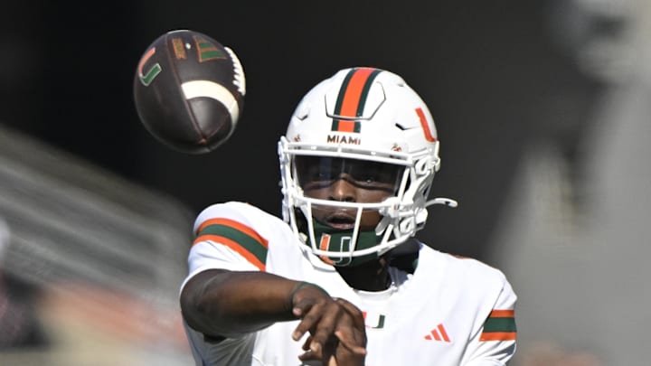 Oct 19, 2024; Louisville, Kentucky, USA;   Miami Hurricanes quarterback Cam Ward (1) passes the ball against the Louisville Cardinals during the first half at L&N Federal Credit Union Stadium. Miami defeated Louisville 52-45. Mandatory Credit: Jamie Rhodes-Imagn Images
