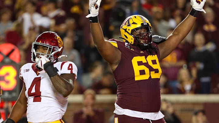 Oct 5, 2024; Minneapolis, Minnesota, USA; Minnesota Golden Gophers offensive lineman Aireontae Ersery (69) celebrates quarterback Max Brosmer's (16) touchdown against the USC Trojans during the first half at Huntington Bank Stadium. Mandatory Credit: Matt Krohn-Imagn Images
