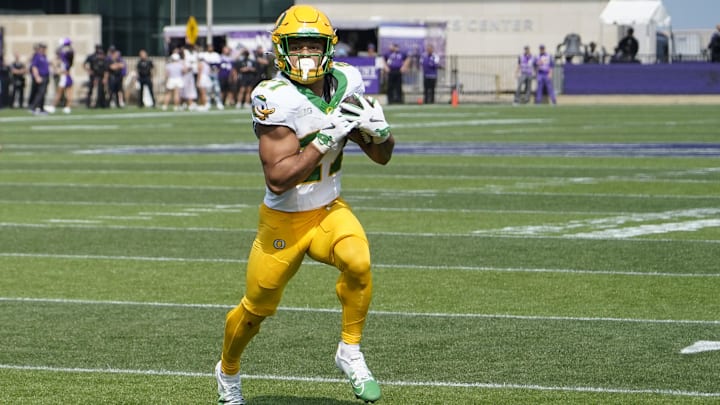 Sep 13, 2025; Evanston, Illinois, USA; Oregon Ducks running back Jayden Limar (27) runs for a touchdown against the Northwestern Wildcats during the first half.