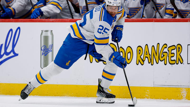 Apr 5, 2026; Denver, Colorado, USA; St. Louis Blues right wing Jordan Kyrou (25) controls the puck in the third period against the Colorado Avalanche at Ball Arena. Mandatory Credit: Isaiah J. Downing-Imagn Images