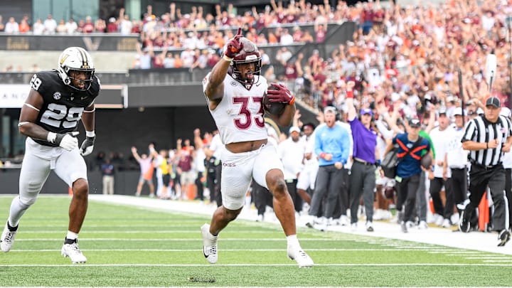 Aug 31, 2024; Nashville, Tennessee, USA;  Virginia Tech Hokies running back Bhayshul Tuten (33) scores a touchdown against the Vanderbilt Commodores] during the second half at FirstBank Stadium. Mandatory Credit: Steve Roberts-Imagn Images