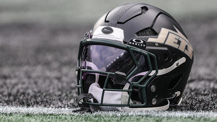 Dec 7, 2025; East Rutherford, New Jersey, USA; A general view of a Gotham City football rivalries helmet resting on the field before the game against the Miami Dolphins at MetLife Stadium. Mandatory Credit: Vincent Carchietta-Imagn Images