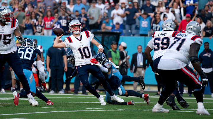 New England Patriots quarterback Drake Maye (10) throws while in the grasp of Tennessee Titans safety Mike Brown (44) during their game at Nissan Stadium in Nashville, Tenn., Sunday, Nov. 3, 2024. It was the last play of regulation and the New England Patriots running back Rhamondre Stevenson (38) came up with the reception in the end zone to force overtime. The play lasted more than 11 seconds as Maye kept the play alive under constant pressure.
